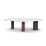 Elodie dining table by Nolita Harbour, showcasing a modern design with three legs in rich walnut wood and a sleek Estremoz marble top