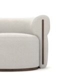 Close-up of Camille Armchair's walnut details and plush fabric upholstery