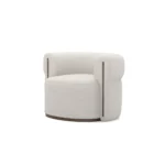Camille armchair by Nolita Harbour, bouclé upholstered armchair with walnut base and sculptural rounded silhouette.