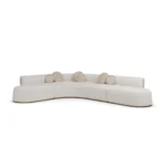 Camille bouclé sofa by Nolita Harbour, luxury sectional sofa with sculptural curves and walnut base, refined upholstery.