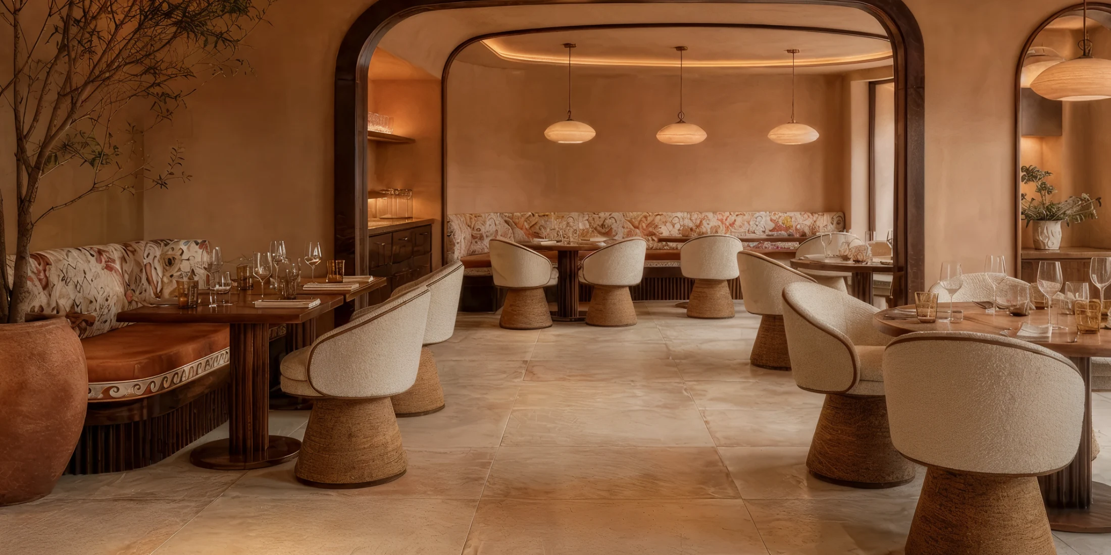 Caroline dining chair by Nolita Harbour, bouclé upholstered chair with cone base and walnut plinth, sculptural seating in a contemporary dining space.