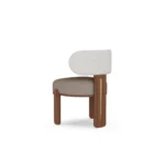 Diane dining chair by Nolita Harbour, upholstered bouclé seat with crescent back and sculptural walnut base.