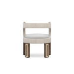 A sophisticated Goldie Dining Chair with walnut matte legs featuring polished brass details, and upholstered in a combination of linen fabric and boucle for added comfort.