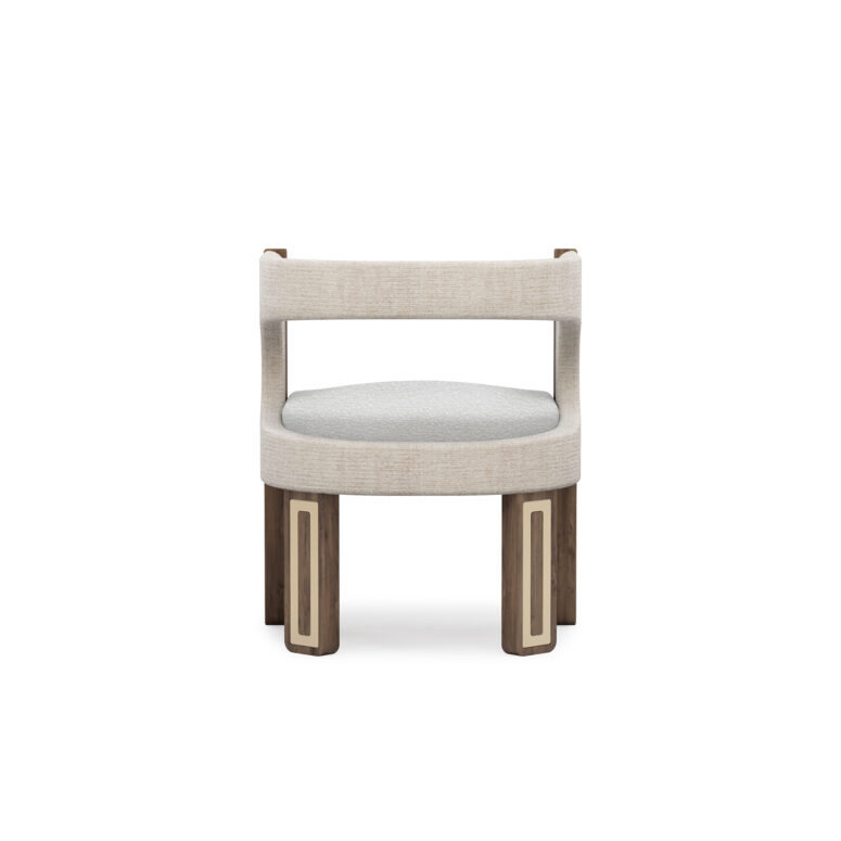 A sophisticated Goldie Dining Chair with walnut matte legs featuring polished brass details, and upholstered in a combination of linen fabric and boucle for added comfort.