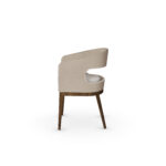 Side view of Tamara Dining Chair showcasing walnut legs and open-back design