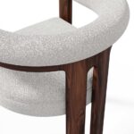 Mathilde dining chair with a unique three-leg walnut base and plush bouclé fabric upholstery, offering both comfort and modern elegance for dining spaces.