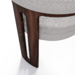 Mathilde dining chair with a unique three-leg walnut base and plush bouclé fabric upholstery, offering both comfort and modern elegance for dining spaces.