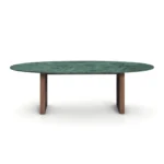 Emerald Dining Table, a refined dining table by Nolita Harbour crafted in green marble, walnut, and rattan, with a smooth oval surface