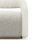 Emma armchair by Nolita Harbour, bouclé upholstered armchair with walnut plinth, sculptural curved detailing, and refined modern craftsmanship.