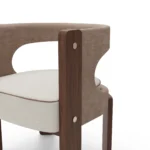 Fay bouclé dining chair by Nolita Harbour details, luxury upholstered chair with sculpted walnut base and refined cut-out back.
