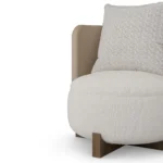 Margot wood base armchair detail by Nolita Harbour, leather accent chair with bouclé upholstery and modern tailored silhouette.