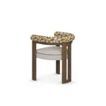 Mathilde contemporary dining chair by Nolita Harbour, bouclé upholstered seat with walnut legs and sculptural arm detail.