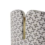 Melli contemporary dining chair detail by Nolita Harbour, upholstered chair with curved shell, walnut base, and sculptural brass accent.