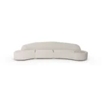 Nathalie II upholstered sofa by Nolita Harbour, bouclé sectional with recessed walnut base and seamless built-in side table.