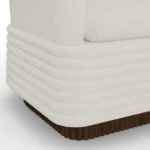 Nina armchair detail by Nolita Harbour, bouclé upholstered chair with walnut frame and calm sculptural lounge design.