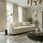 Nina sofa by Nolita Harbour, bouclé upholstered sofa with recessed walnut base, clean linear design in a bright luxury contemporary living room.