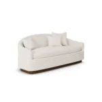 Nina sofa by Nolita Harbour, bouclé upholstered sofa with recessed walnut base and clean, linear sculptural silhouette.
