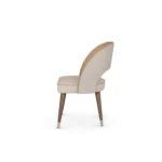 Paris luxury dining chair by Nolita Harbour, curved upholstered chair with solid walnut base and tailored silhouette.