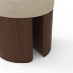 Pauline upholstered stool detail by Nolita Harbour, bouclé fabric seat on carved walnut base, compact design with modern proportions.