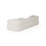 Soléne modular sofa by Nolita Harbour in bouclé, curved sectional with cylindrical armrests and sculptural, low-profile form.