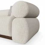 Soléne bouclé sofa by Nolita Harbour, luxury sectional sofa with rounded cushions and recessed walnut base, architectural silhouette.