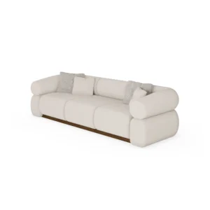 Soléne sectional sofa by Nolita Harbour, bouclé upholstered sofa with walnut base and cylindrical arms, sculptural curved design.