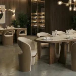 Berta dining chair by Nolita Harbour, velvet upholstered chair with walnut base and sculptural open-back silhouette in a refined dining setting.