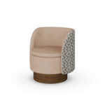 Beige luxury armchair with patterned fabric back and sides, and a walnut base, designed by Nolita Harbour. 45 degree