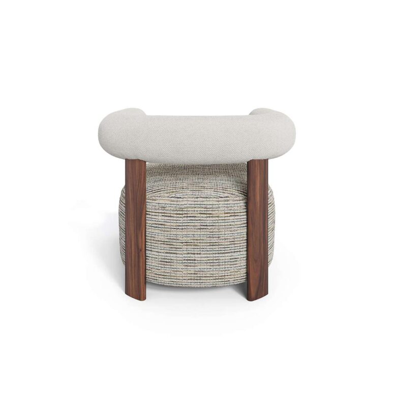 Modern luxury armchair with rounded cushioned backrest, neutral upholstery, patterned fabric seat, and walnut legs, designed by Nolita Harbour. Back view