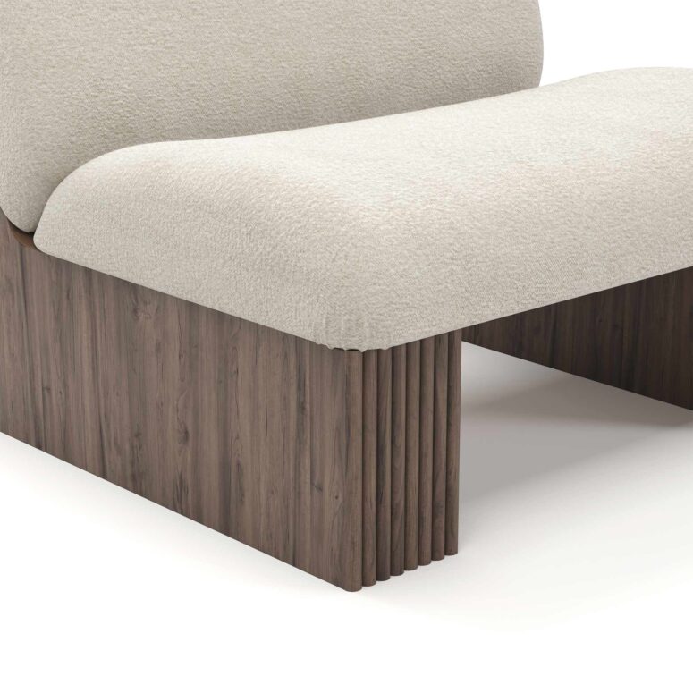 Modern armchair with cream upholstery, featuring ribbed walnut base and plush seating, designed by Nolita Harbour. detail view