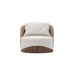 Round luxury armchair with cream fabric, beige accents, and a walnut wood wavy base, featuring a plush cushion, designed by Nolita Harbour. Front view