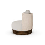 Beige and cream luxury armchair with patterned cushion and ribbed walnut base, designed by Nolita Harbour. Side view