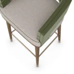Ava bar stool detail by Nolita Harbour, velvet upholstered chair with walnut base, brass accents, and refined architectural silhouette.