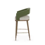 Ava upholstered bar chair by Nolita Harbour, velvet seat with walnut frame and brass footrest, elegant modern design.