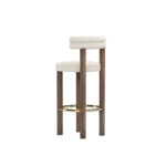 Modern luxury bar chair with cream upholstery, double-roll backrest, walnut legs, and brass-finished footrest, designed by Nolita Harbour. 45 degree