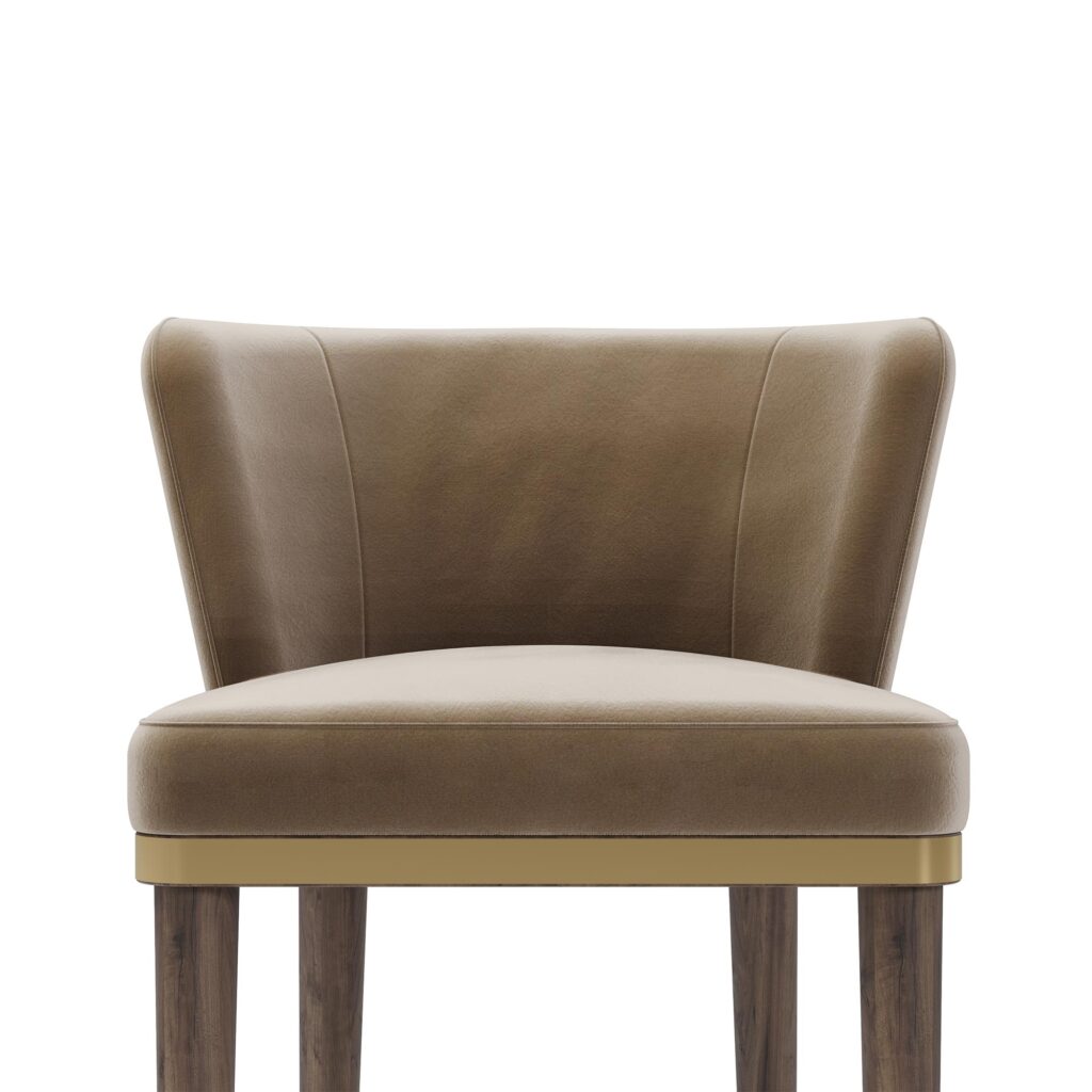 Taupe leather bar chair with a curved backrest, walnut frame, and brass accents, designed by Nolita Harbour. detail view