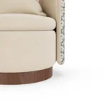 Carrie velvet armchair detail by Nolita Harbour, luxury lounge chair with curved shell, circular seat, and refined walnut base.