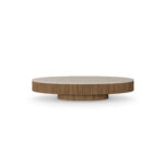 Round Matti coffee table with a travertine top and ribbed walnut base, designed by Nolita Harbour. front view