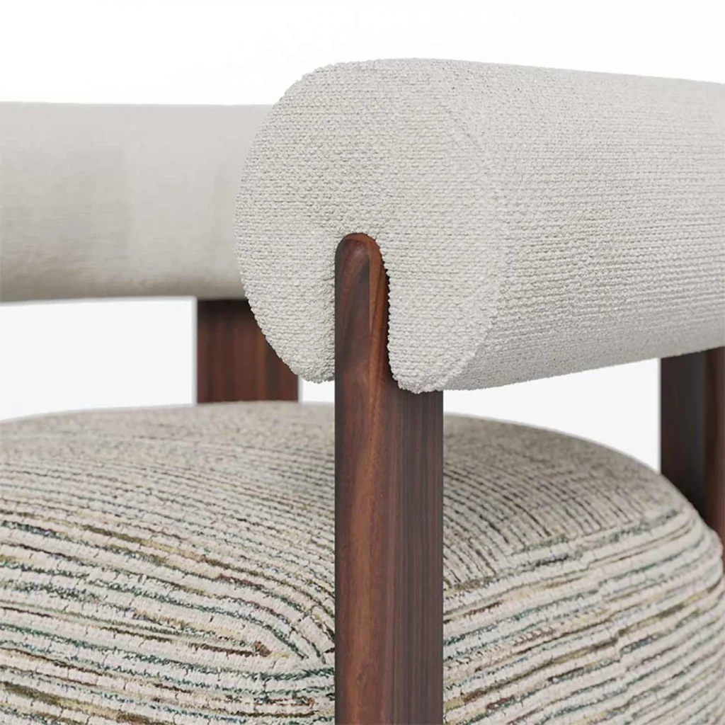 Claire contemporary armchair detail by Nolita Harbour, upholstered chair with cylindrical arms and elegant walnut structure.