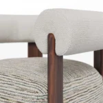Claire contemporary armchair detail by Nolita Harbour, upholstered chair with cylindrical arms and elegant walnut structure.