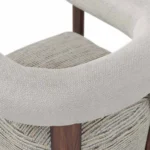 Claire designer armchair detail by Nolita Harbour, luxury upholstered chair with visible wood frame and sculptural modern form.