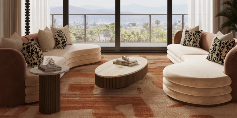 Latte sofa by Nolita Harbour, curved velvet and bouclé sectional sofa with walnut base, sculptural seating in a light-filled modern living room.