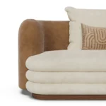 Latte curved sofa by Nolita Harbour in velvet and bouclé, upholstered sofa with continuous back and warm, refined silhouette.