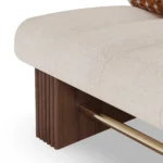 Mika designer armchair detail by Nolita Harbour, sculptural lounge chair with continuous bouclé shell and refined walnut base.