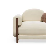 Noah luxury sofa detail by Nolita Harbour, velvet sectional sofa with modular layout and grounded walnut plinth, elegant proportions.