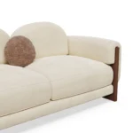 Noah designer sofa detail by Nolita Harbour, velvet sectional sofa with sculptural form and continuous walnut base, modern lounge seating.