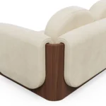 Noah velvet sofa detail by Nolita Harbour, luxury sectional sofa with modular design and continuous walnut plinth, refined silhouette.
