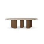 Santi Dining Table, an architectural dining table by Nolita Harbour in travertine, ribbed wood, and brass detailing.