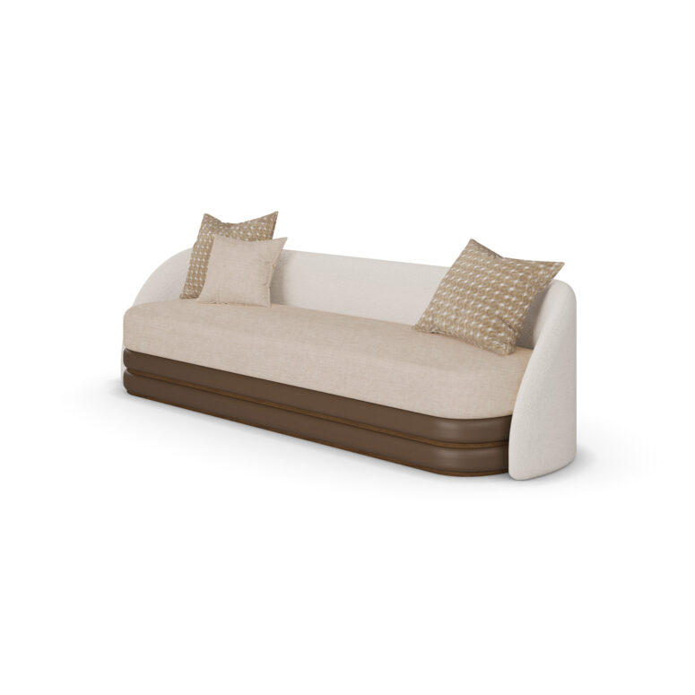 Beige and cream luxury sofa with a brown base and patterned cushions, designed by Nolita Harbour. 45 degree view