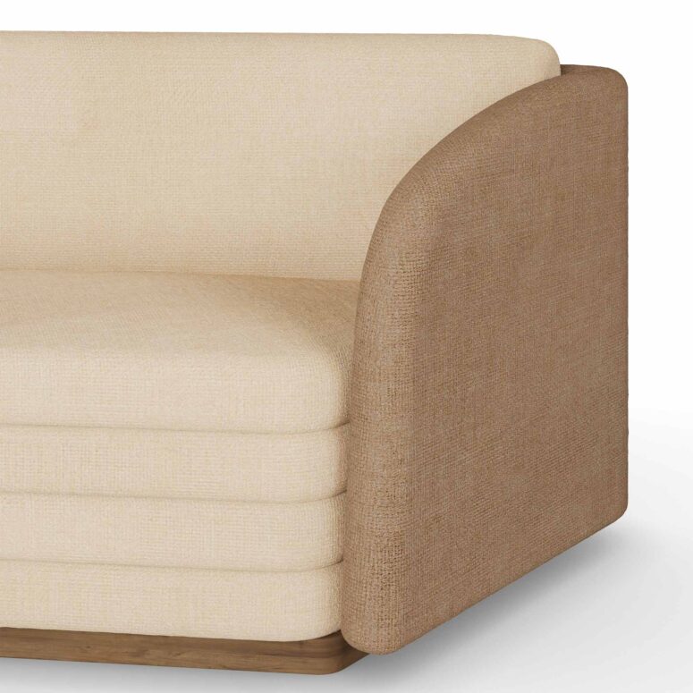 Luxury sofa with cream-colored upholstery, beige fabric accents, and patterned cushions, featuring a low-profile design by Nolita Harbour. Detail view